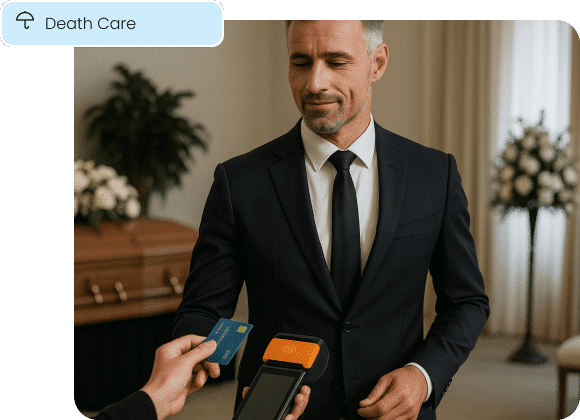 A funeral director discreetly accepts a credit card payment, illustrating professional payment solutions for the death care industry.